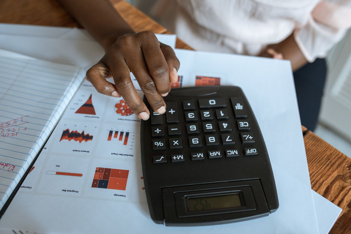 Calculator and handwritten notes on a desk, used to work out Google Ads management pricing